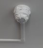 A smoke detector on the ceiling of a hotel room, clogged by an unknown substance.